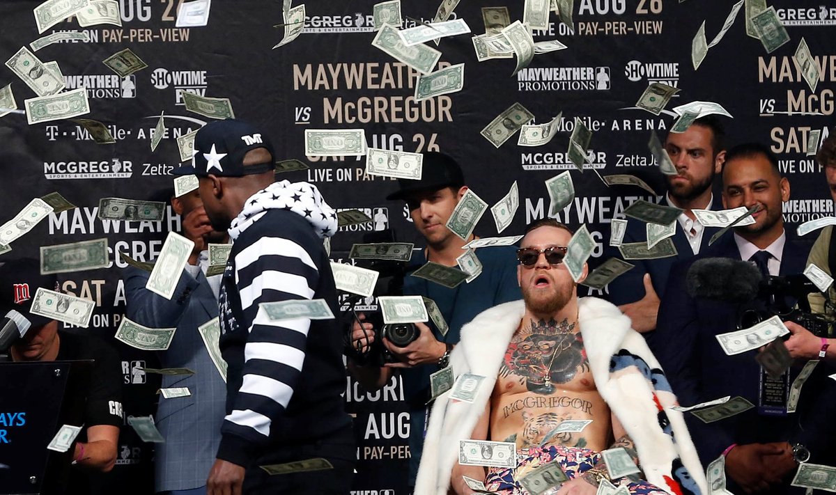 Floyd Mayweather throws money at Conor McGregor