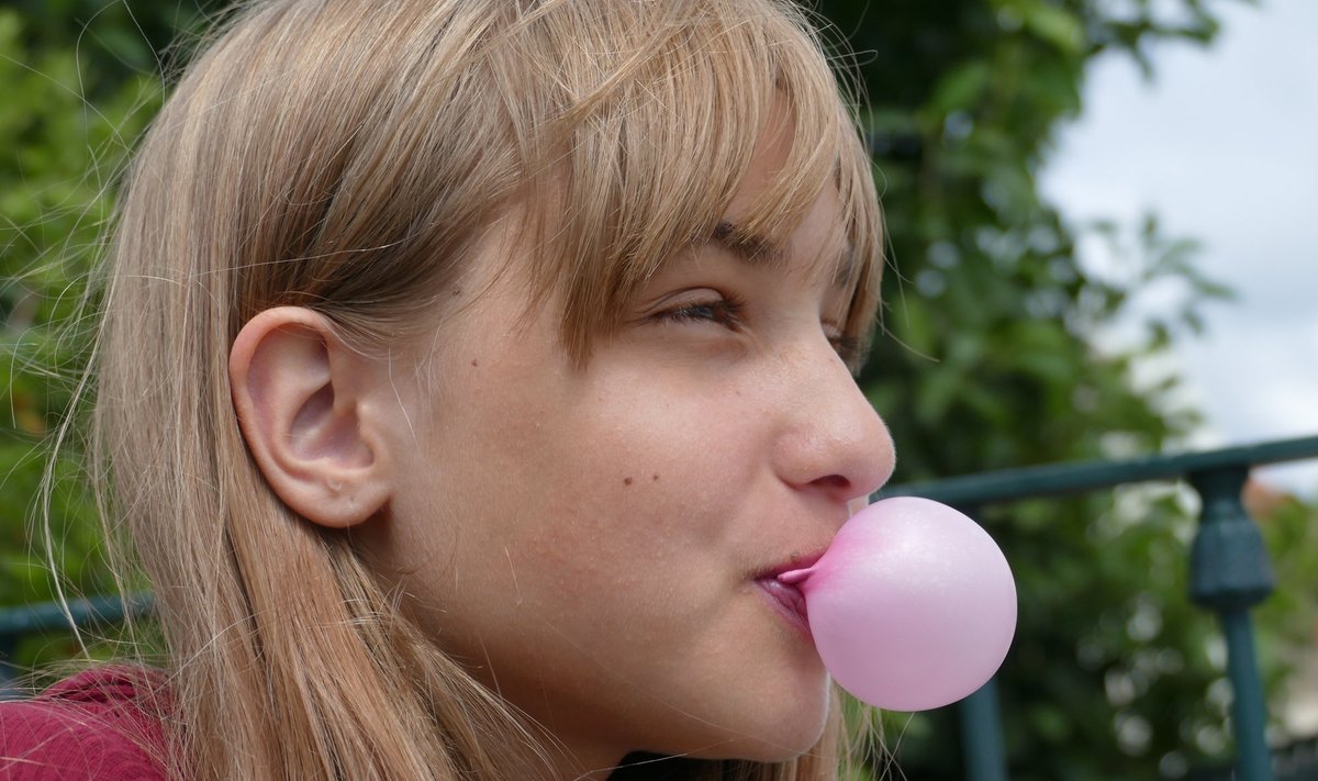 Mergina kramto gumą