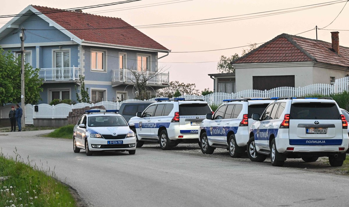 Police block a road in the village of Dubona near the town of Mladenovac, about 60 kilometres (37 miles) south of Serbia's capital Belgrade, on May 05, 2023, after at least eight people were killed and 13 injured in a drive-by shooting. - Near Mladenovac on May 4, 2023, an attacker armed with an automatic weapon opened fire from a moving vehicle before fleeing, state-run RTS television reported. Police were searching for the attacker. (Photo by ANDREJ ISAKOVIC / AFP)