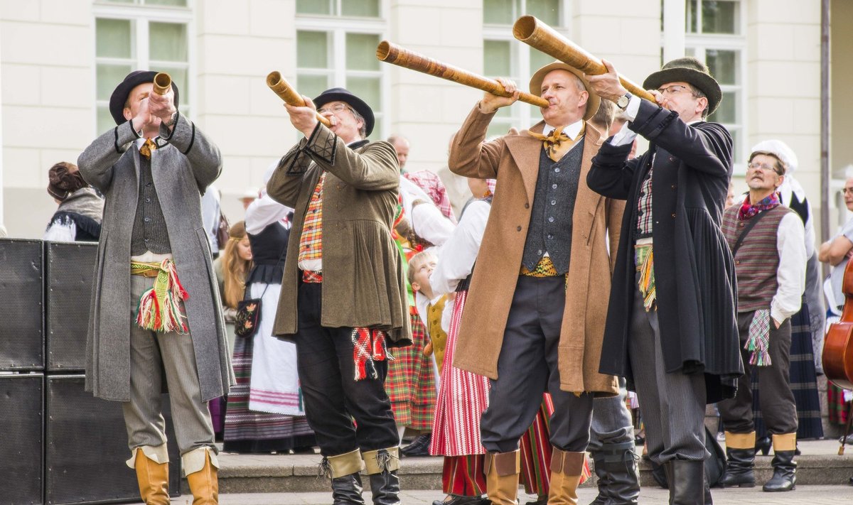 Men in traditional Lithuanian costumes playing the ragas