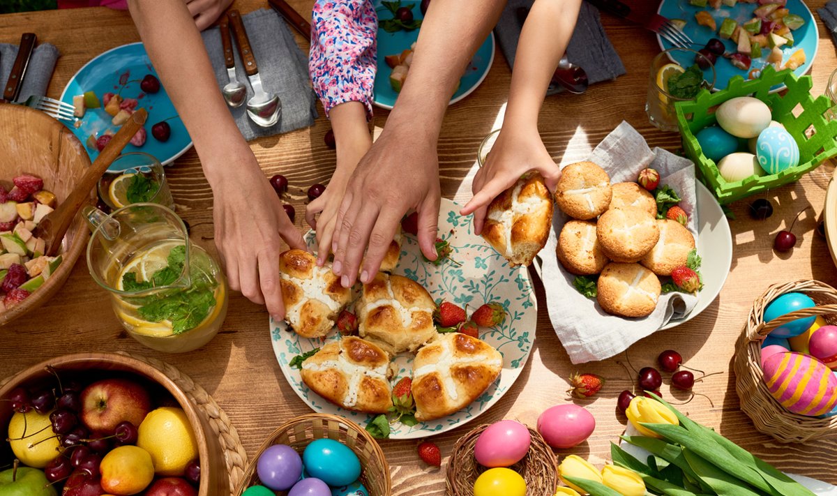 High angle view of family taking sweet buns when they having Easter dinner together