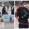 Kelia paniką dėl ginkluoto prancūzų pareigūno paplūdimyje, bet policijos atstovai ramina – nieko čia neįprasto