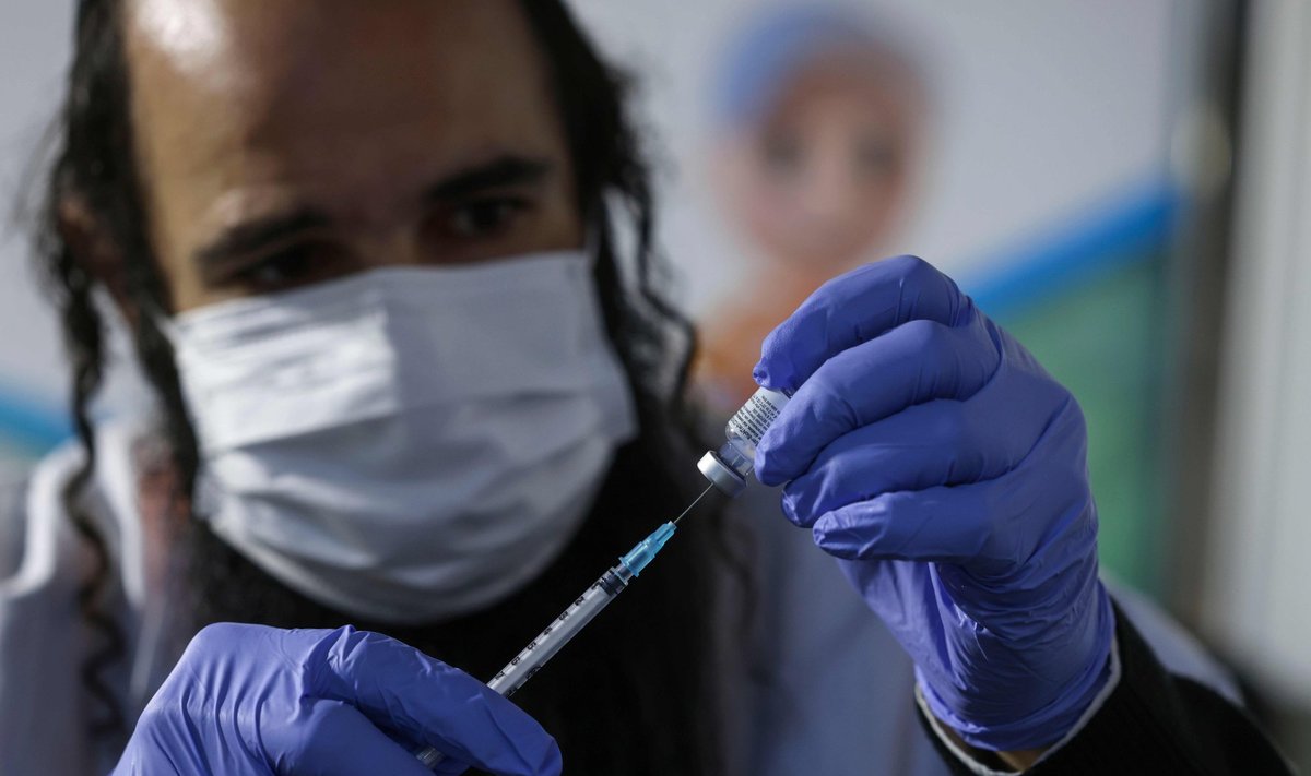 A health worker prepares a dose of the Pfizer-BioNtech COVID-19 vaccine at Clalit Health Services in Jerusalem, on January 24, 2021. - Since the rollout of vaccinations one month ago, more than 2.5 million of Israel s nine-million-strong population have been vaccinated already, the health ministry said on January 22.