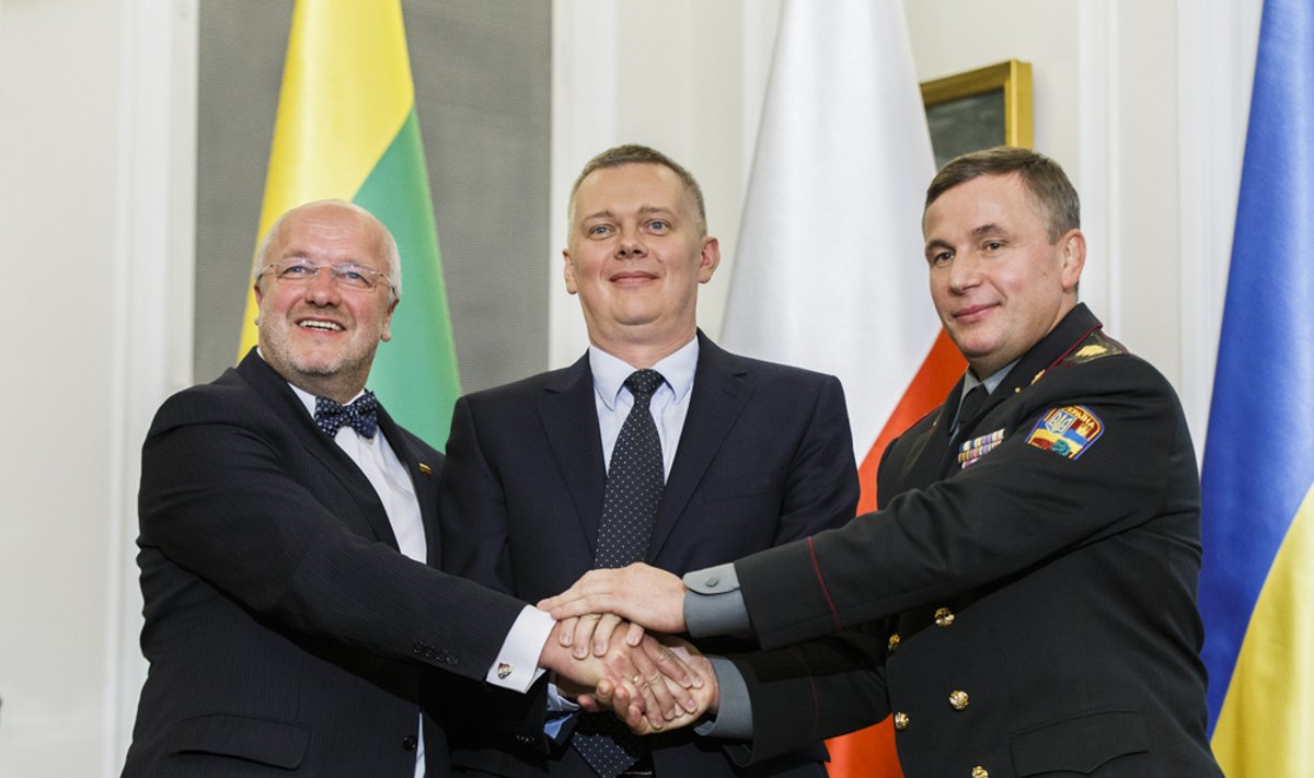 Ukrainian Defense Minister Valeriy Heletey (R), Polish Defense Minister Tomasz Siemoniak (C) and Lithuanian Defense Minister Juozas Olekas shake hands after signing an agreement on the creation of a joint military brigade on Sept. 19 in Warsaw.