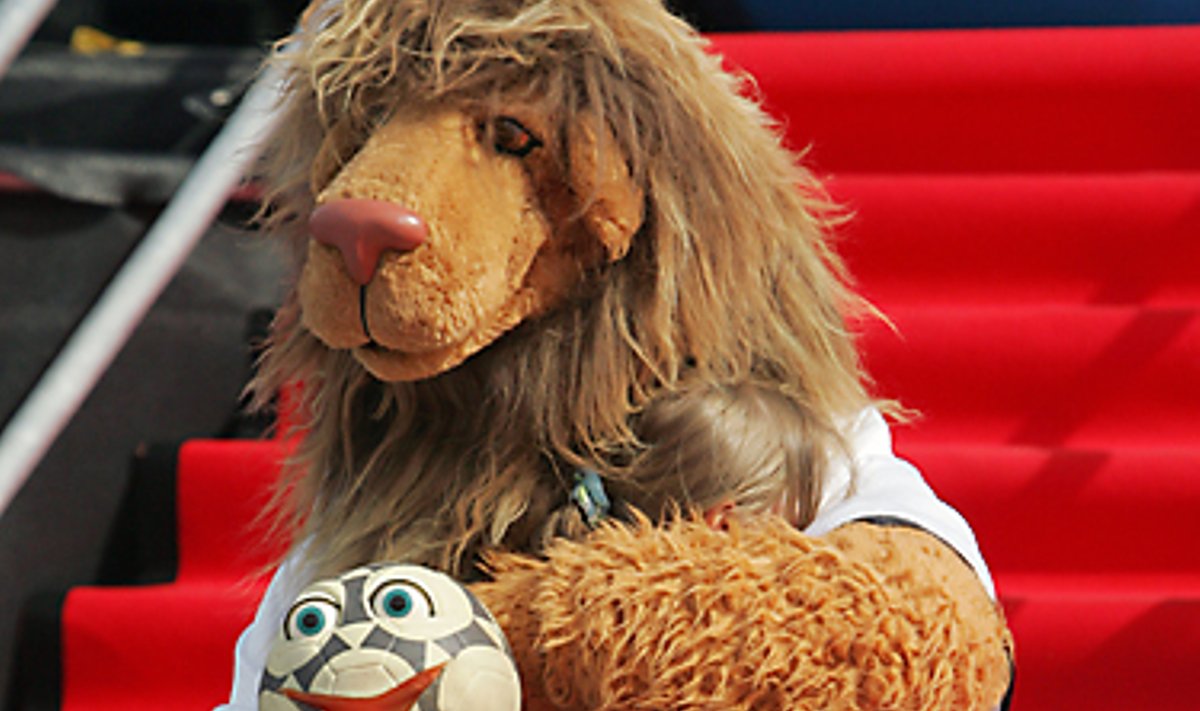 Pasaulio futbolo čempionato Vokietijoje talismanas – liūtukas – laiko apkabinęs mergaitę. 