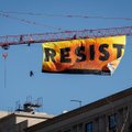 Vašingtono centre protestuotojai plakatu „Resist“ ant krano ragina priešintis D. Trumpui