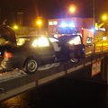 Bėglių automobilį ant tilto pervėrė turėklai, keleivis iškrito į upę