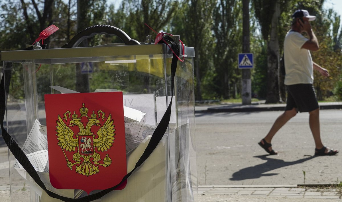 epa10831645 A man walks past a ballot box with the coat of arms of Russia during early voting for the local elections in Mariupol, Russian-controlled Ukraine, 31 August 2023. Elections of various levels will be held in Russia on 10 September 2023, including by-elections of deputies to the State Duma, elections of heads of 26 constituent entities of the federation, and elections of deputies of legislative bodies of state power in 16 constituent entities of the Russian Federation. The Central Election Commission of Russia has scheduled elections in the self-proclaimed Donetsk Peopleâs Republic, Luhansk, Zaporizhzhia and Kherson regions on a Single Voting Day on 10 September.  EPA/STRINGER