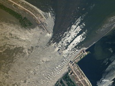 This handout SkySat image taken and released by Planet Labs PBC on June 6, 2023 shows water flowing through the damaged Kakhovka HPP dam in southern Ukraine. The partial destruction on June 6, 2023 of the major Russian-held dam in southern Ukraine unleashed a torrent of water that flooded two dozen villages forcing mass evacuation, sparking fears of a humanitarian disaster near the war's front line. Moscow and Kyiv traded blame for ripping a gaping hole in the Kakhovka dam as expectations built over the start of Ukraine's long-awaited offensive. (Photo by 2023 Planet Labs PBC / AFP) / RESTRICTED TO EDITORIAL USE - MANDATORY CREDIT "AFP PHOTO / HANDOUT / Planet Labs PBC " - NO MARKETING - NO ADVERTISING CAMPAIGNS - DISTRIBUTED AS A SERVICE TO CLIENTS