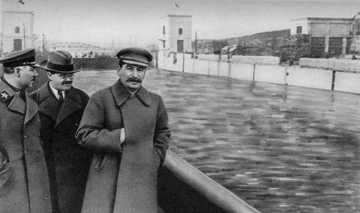 Voroshilov, Molotov, and Stalin.  Yezhov airbrushed out of history by unknow Soviet artist  Public Domain
