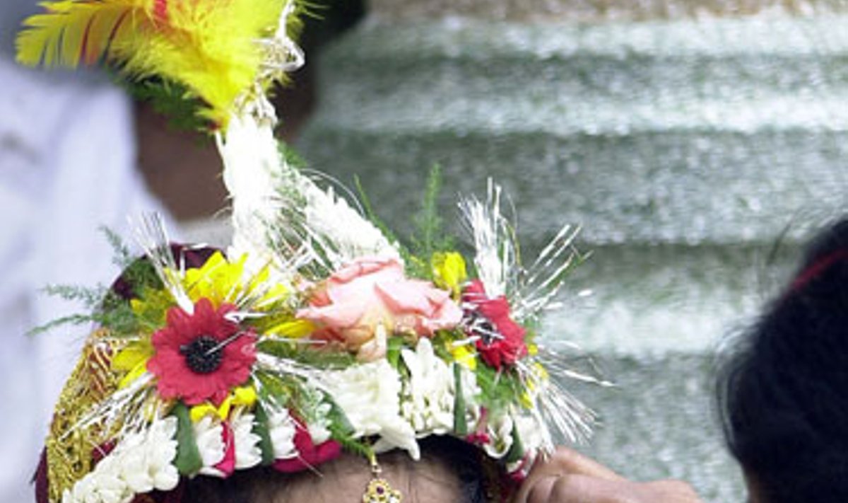 Indė daro makiažą mergaitei, kuri vaidins “kumari” indų Dievo Rama gimtadienio šventėje. 