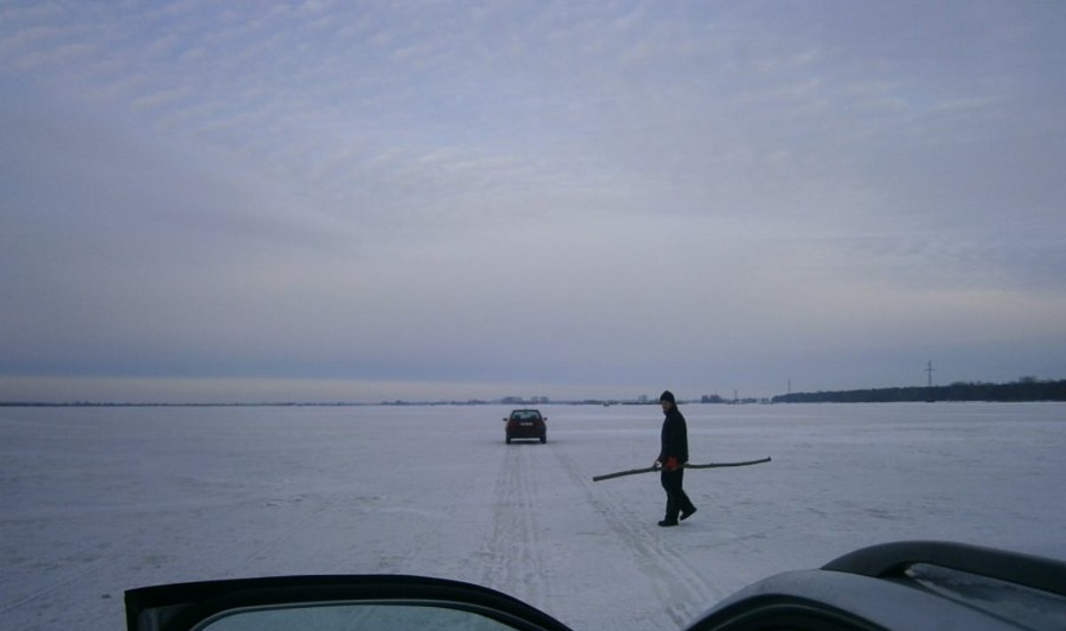 Ledo kelią potvynio zonoje ženklina S.Knapkis. Mašinos jau važiuoja saugiai  / D. Plikšnienės nuotr.