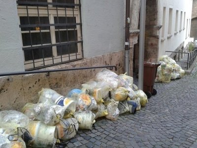 Plastikui skirti maišeliai Vokietijoje, sudėti gatvėje laukia šiukšliavežės