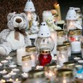Hundreds of candles lit outside Seimas against violence against children